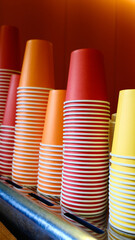 Stacked colorful paper cups on cafe counter