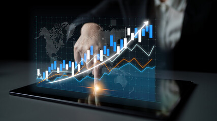 A businessman analyzes an upward financial growth chart displayed on a tablet, showcasing digital...