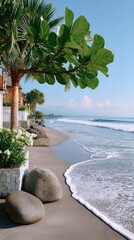 Vibrant Green Tropical Leaves Overlooking a Sunlit Sandy Beach with Gentle Ocean Waves and a Clear Blue Sky in the Daytime