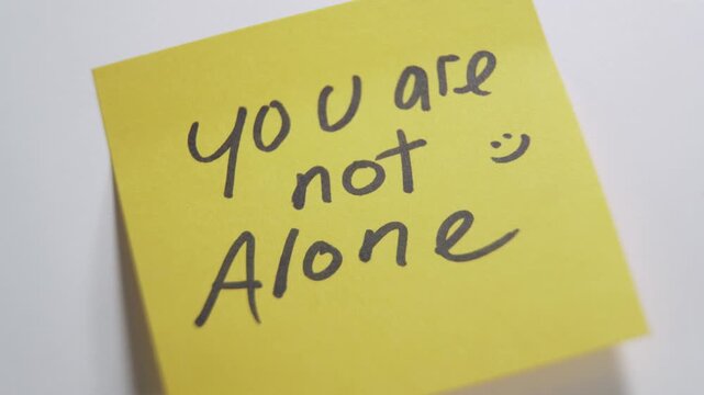 Person sticking positive message on white background