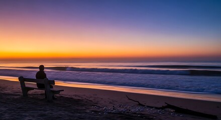 Fototapeta premium Contemplative Moment - Person on Bench at Beach at Sunset.