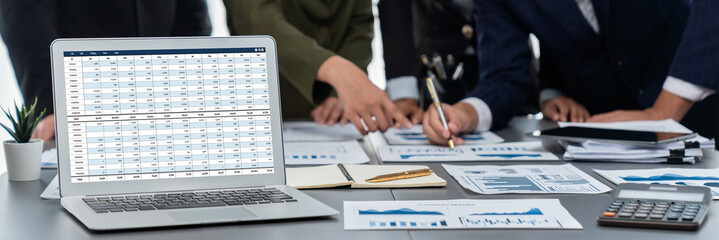 Panorama shot analyst team utilizing BI Fintech to analyze financial report with laptop....