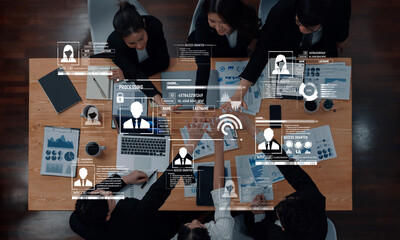 A diverse business team engages in a collaborative project around a conference table, integrating...