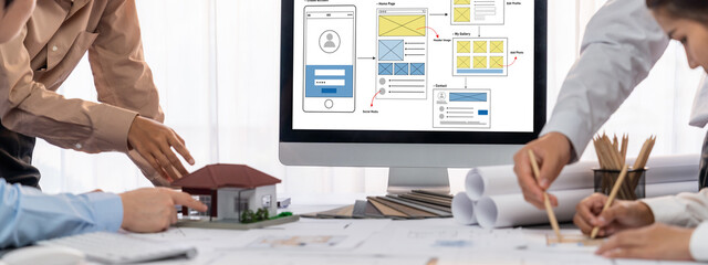 Group of interior architect designer discussing together on blueprint and laptop screen display...