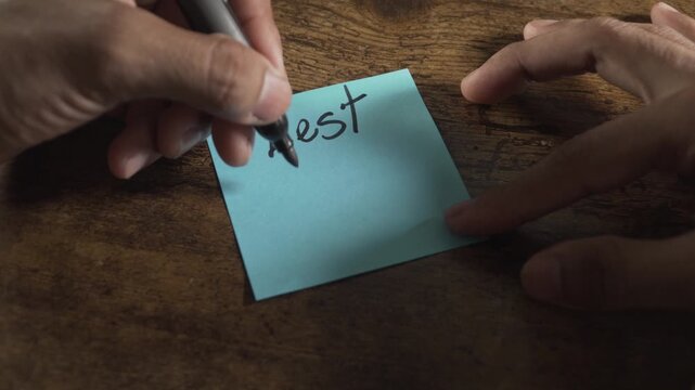 Person writing let's talk on a sticky note