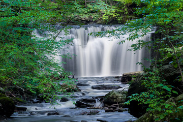 Cascade of waterfalls long exposure shot in scenic Ricketts Glen state park, Pennsylvania in summer time