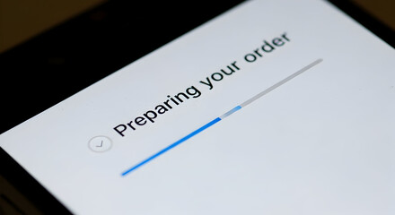 Preparing Your Order: A Close-Up View Of A Smartphone Screen Indicating A Progress Bar Loading For An Online Order Transaction