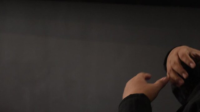 Sign language interpreters (JBI) use sign language while sitting in front of a camera.
