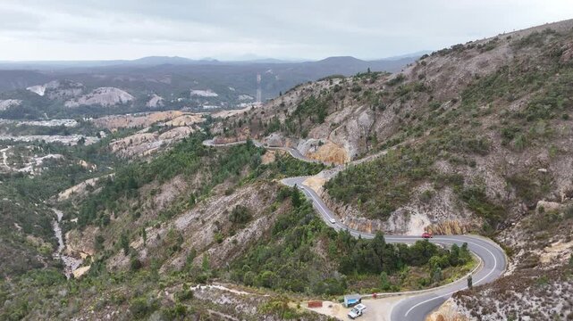 Aerial drone shot of scenic 99 Bends Road On Lyell Highway, A10 Route in Tasmania, a curvy Winding Road Over The Mountains Above Queenstown in Australia.