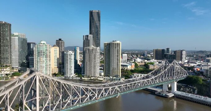 4K aerial pull out camera tracking view of the iconic Story Bridge and east side of Brisbane CBD with Brisbane River below where CityCat ferries commute passengers, Brisbane, Queensland, Australia