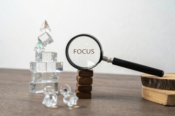 Focus Magnifying Glass on Crystal Blocks and Wooden Pieces Arrangement