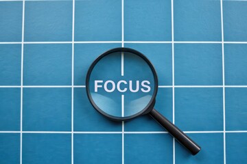 Magnifying Glass Over Text Focus on Blue Grid Background