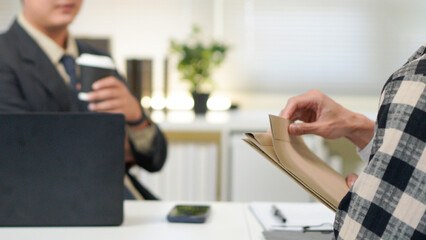 Application, hands and interview with business people in human resources office for hiring or recruitment. CV, documents or resume with manager and candidate talking in office for job opportunity