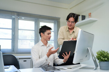 Businessmen Discussing Over Document In Office
