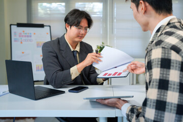 Businessmen Discussing Over Document In Office