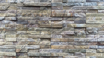 Natural stacked stone wall background with rustic texture and earthy tones. Perfect for architecture, design, or construction themes, offering a rugged and realistic stone surface pattern.