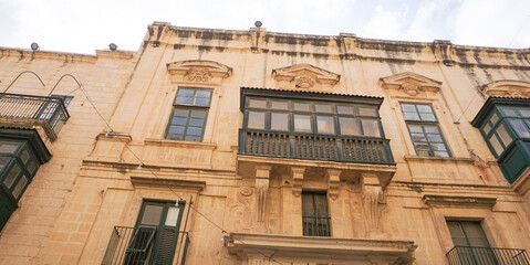 View of old building with windows, balconies in city. Republic of Malta, the picturesque city of Valetta, Malta.