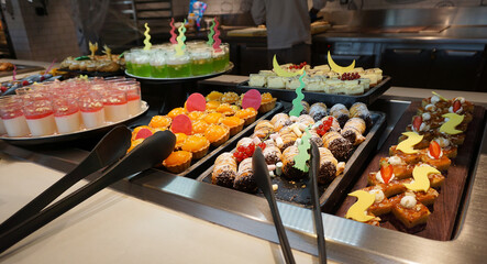 Dining Room Buffet aboard the abstract luxury cruise ship. Selective focus. Sweet cakes