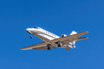 Private jet flying in clear blue