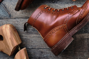 Wingtip Brogue Boots and Accessories on Wooden Table