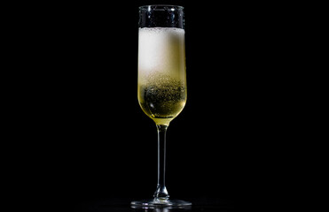 Festive pour of champagne with bubbles. Champagne glass shining with effervescent bubbles. Sparkling wine with bubbly champagne in luxury glass. Splash of champagne for party celebration.
