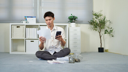 male office worker holds bills in hands counting amount of utilities together, man accountant makes report about household expenses