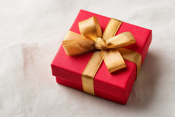 Red gift box with gold ribbon present for christmas and valentine's day