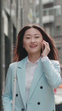 confident asian businesswoman walking city street vertical video modern professional lifestyle career growth success leadership motivation corporate image executive woman confidence