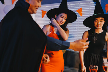 Obraz premium Joyful office Halloween party with coworkers in costumes, celebrating with drinks and laughter, fostering teamwork and festive spirit