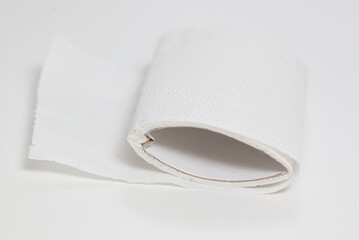 A roll of toilet paper is on a white surface