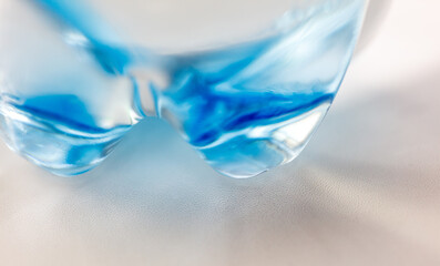 A bottle of water with blue liquid inside