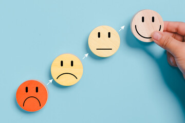 Hands holding blue happy smile face for medical care concept. Mental health positive thinking.