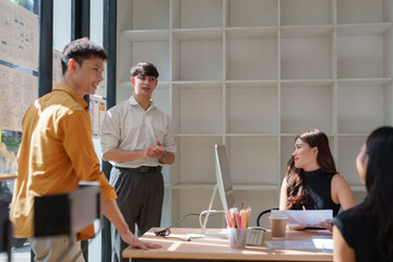 Business team collaborating, discussing creative office project