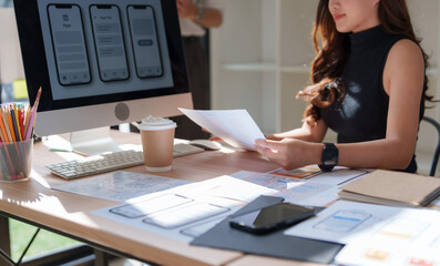 Woman designing mobile application user interface wireframes