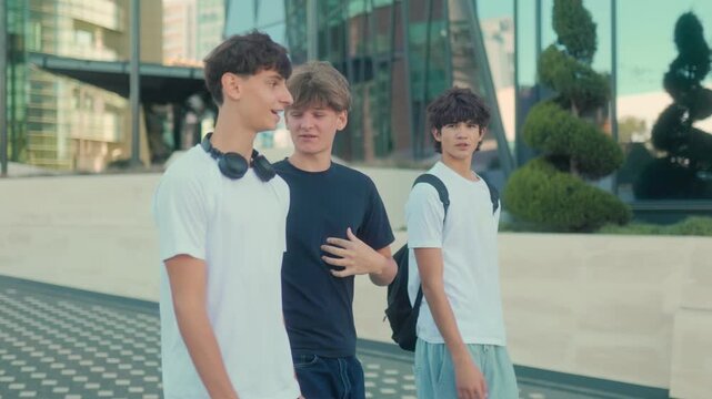 Group of smiling teenage boys walking outdoors with carefree summer energy