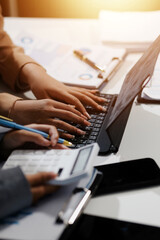 Close up Business woman using calculator and laptop for do math finance on wooden desk, tax, accounting, statistics and analytical research concept