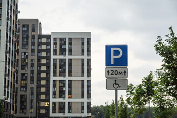 Urban residential area with modern apartment buildings parking sign indicating a handicapped...