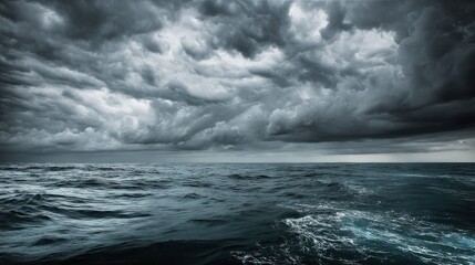 Fototapeta premium A dramatic seascape featuring turbulent waves under a moody, cloud-filled sky, conveying a sense of power and unrest in nature.