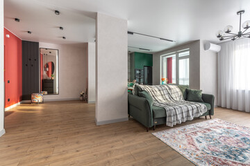 Spacious Modern Living Room with Green Sofa and Open Layout