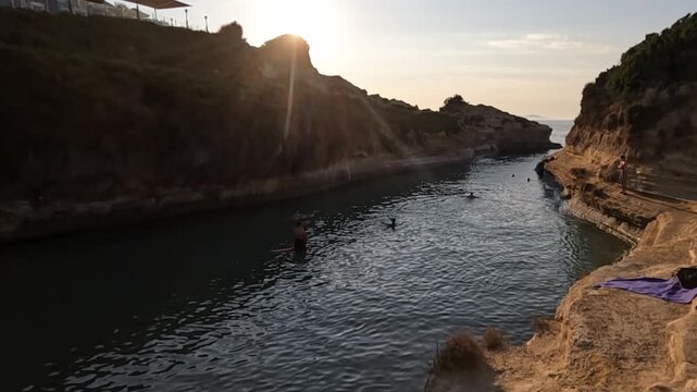 Golden hour sunset view of the iconic Canal d'Amour (Love Canal) in Corfu, Greece