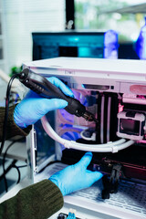 Closeup of technician repairing PC hardware using soldering tool in high-tech lab, representing...