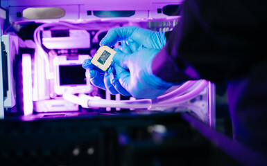 The technician is putting the CPU on the socket of the computer motherboard. electronic engineering electronic repair, electronics measuring and testing, repair
