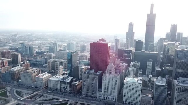 Aerial drone video panning 270 degrees from left to right and showing the skyline buildings in downtown Chicago, Illinois.