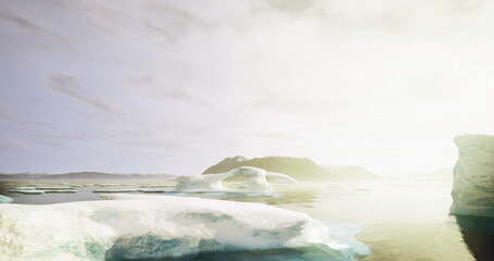 Early morning light casts a warm glow over ice formations in a tranquil water body. The surrounding mountainous landscape enhances the peaceful atmosphere of the scene.