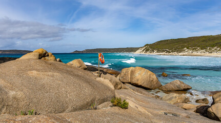 An orange life preserver and rope ready to assist with emergencies off the rocks. Dolphin Cove, Esperance Western Australia.	