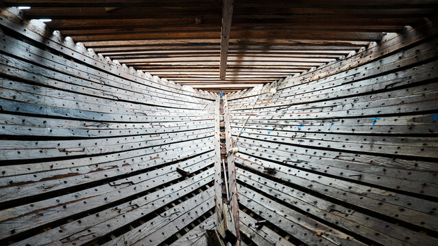 The stringer and frame sections in the construction of a traditional Phinisi wooden ship are linked to each other with bolts and pegs.