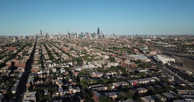 Aerial drone video from the suburbs showing the Chicago, Illinois skyline on the distant horizon as the drone is moving to the right.