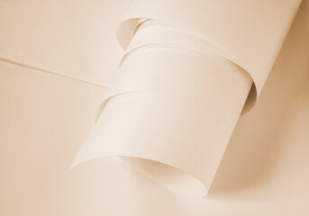Long sheets of paper from a roll in a warm ochre tone.