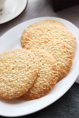 Sesame cookies in a white plate on the table