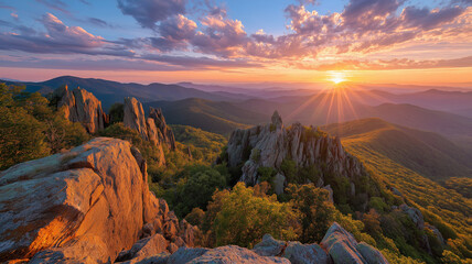 Sunrise over a rugged mountain landscape with vibrant sky and sunburst